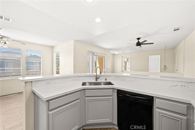 39719 Princeton Way Unit C, Murrieta, CA 92563 - kitchen with black dishwasher, a ceiling fan, gray cabinetry, light wood-type flooring, and light stone counters