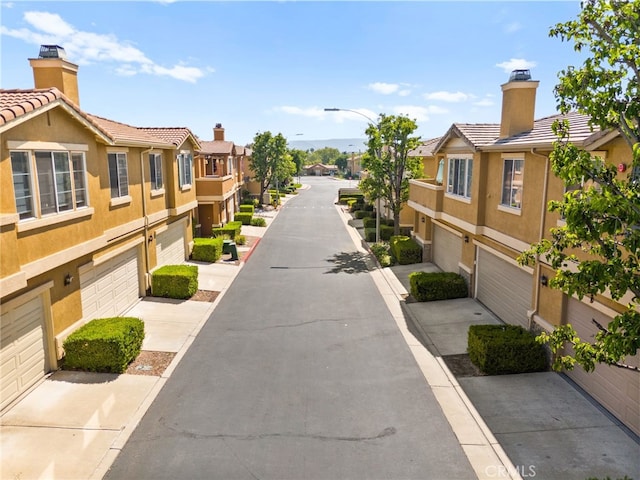 39719 Princeton Way Unit C, Murrieta, CA 92563 - view of home's community with a residential view, an attached garage, and driveway