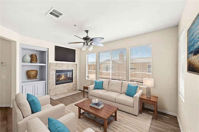 39719 Princeton Way Unit C, Murrieta, CA 92563 - living room with wood finished floors, ceiling fan, a fireplace, and built in features
