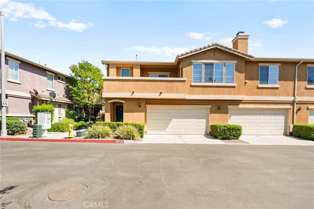 39719 Princeton Way Unit C, Murrieta, CA 92563 - multi unit property featuring stucco siding, a chimney, a tiled roof, and a garage