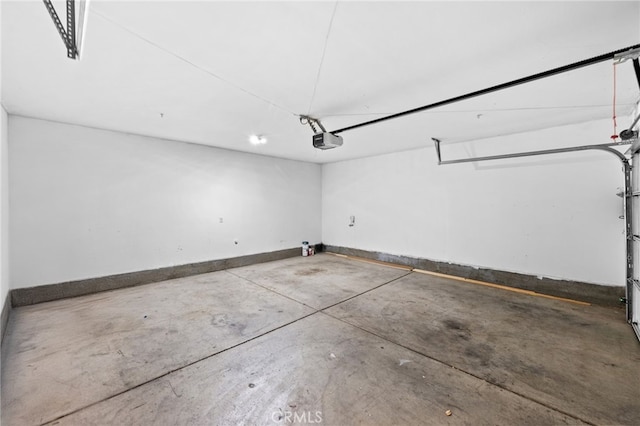 39719 Princeton Way Unit C, Murrieta, CA 92563 - garage with a garage door opener and baseboards
