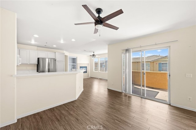 39719 Princeton Way Unit C, Murrieta, CA 92563 - unfurnished living room featuring ceiling fan, wood finished floors, recessed lighting, and a fireplace