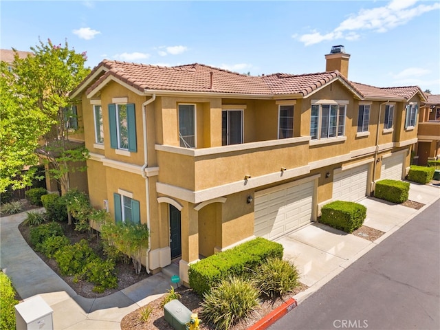39719 Princeton Way Unit C, Murrieta, CA 92563 - view of front facade featuring concrete driveway, a chimney, stucco siding, and an attached garage
