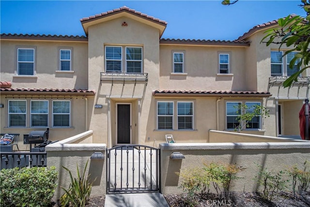 10415 Camellia Ln, Santa Fe Springs, CA 90670 - view of front of home with a fenced front yard, stucco siding, and a tile roof