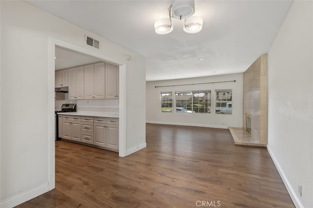 1329 S St Malo St, West Covina, CA 91790 - kitchen featuring stainless steel range oven, open floor plan, dark wood-type flooring, under cabinet range hood, and light countertops