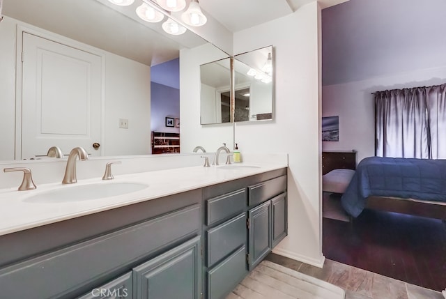 1313 Valley View Rd Unit 103, Glendale, CA 91202 - bathroom featuring double vanity, wood finished floors, and connected bathroom