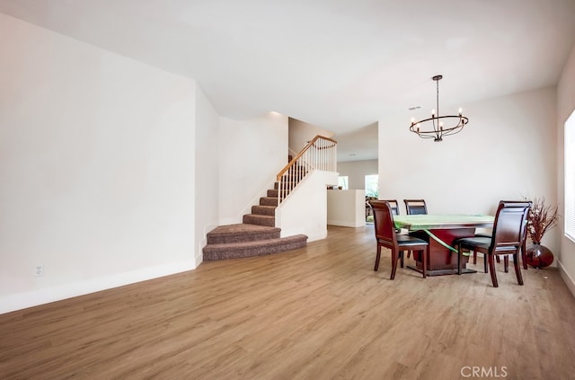 8550 Rolling Hills Dr, Corona, CA 92883 - dining space with wood finished floors, a chandelier, and stairs