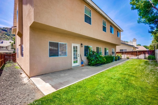 8550 Rolling Hills Dr, Corona, CA 92883 - back of property featuring stucco siding, a fenced backyard, and a patio area