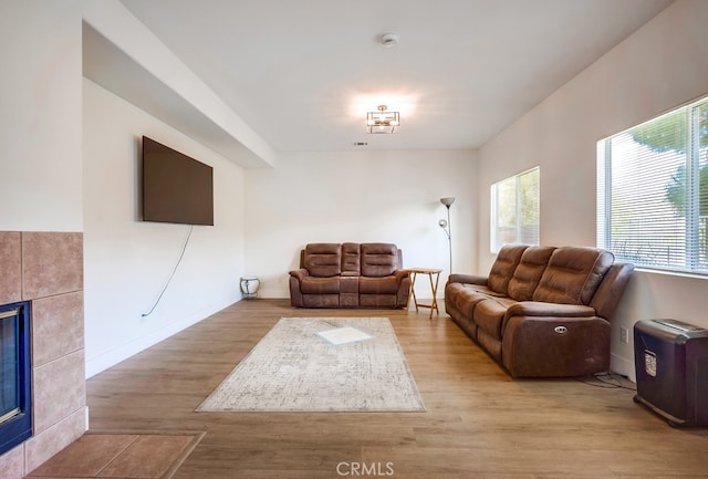 8550 Rolling Hills Dr, Corona, CA 92883 - living area with a tile fireplace, plenty of natural light, and wood finished floors