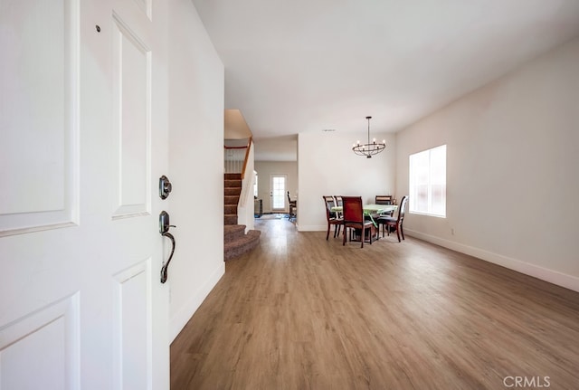 8550 Rolling Hills Dr, Corona, CA 92883 - dining room featuring healthy amount of natural light, stairway, light wood-style floors, and a chandelier