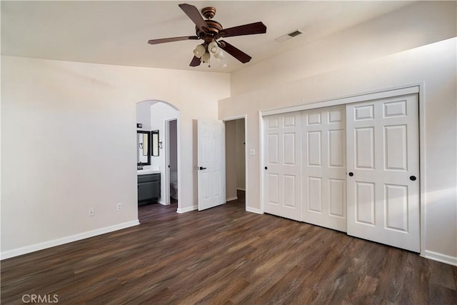 5224 Sierra Caves Ave, Bakersfield, CA 93313 - unfurnished bedroom with arched walkways, lofted ceiling, dark wood-style floors, a closet, and ceiling fan