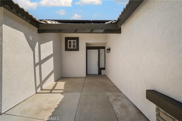 5224 Sierra Caves Ave, Bakersfield, CA 93313 - view of exterior entry featuring stucco siding and a patio area