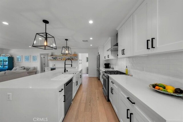 1834 Stearns Dr, Los Angeles, CA 90035 - kitchen with stainless steel appliances, recessed lighting, light wood finished floors, white cabinets, and light countertops