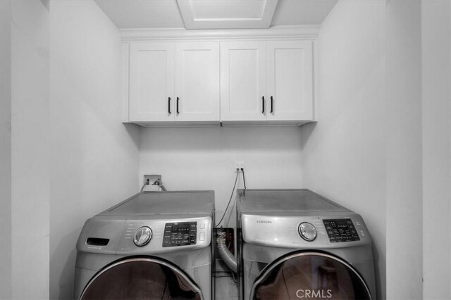1834 Stearns Dr, Los Angeles, CA 90035 - laundry area featuring separate washer and dryer and cabinet space