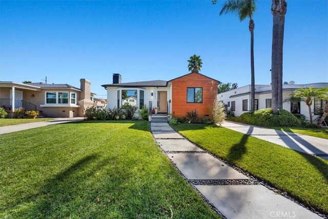 1834 Stearns Dr, Los Angeles, CA 90035 - bungalow-style house with a chimney, a front lawn, and stucco siding