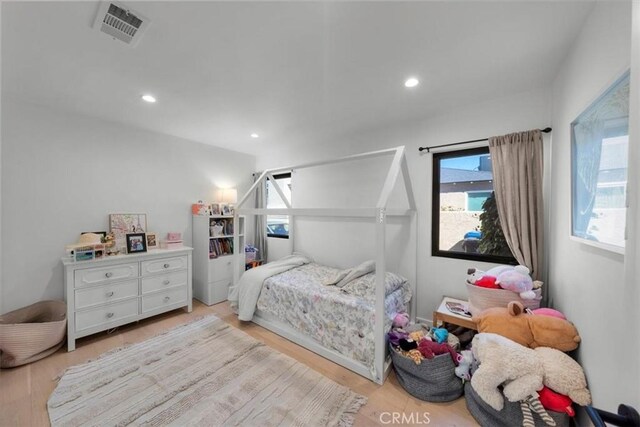 1834 Stearns Dr, Los Angeles, CA 90035 - bedroom featuring multiple windows, light wood-style flooring, and recessed lighting