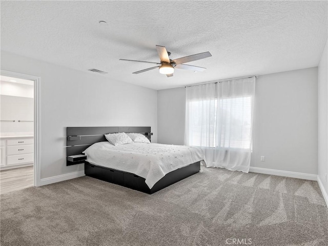 15679 Tuscola Rd, Apple Valley, CA 92307 - bedroom with carpet, a textured ceiling, a ceiling fan, and connected bathroom