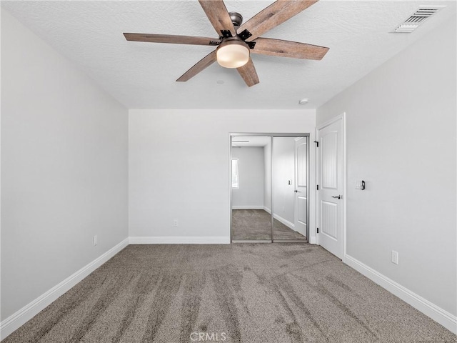 15679 Tuscola Rd, Apple Valley, CA 92307 - unfurnished bedroom featuring carpet flooring, a textured ceiling, a closet, and ceiling fan