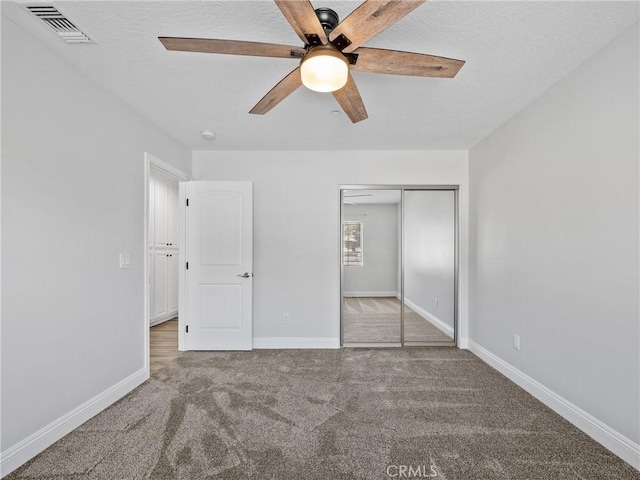 15679 Tuscola Rd, Apple Valley, CA 92307 - unfurnished bedroom with carpet flooring, a closet, ceiling fan, and a textured ceiling