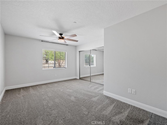 15679 Tuscola Rd, Apple Valley, CA 92307 - unfurnished bedroom with carpet, a textured ceiling, a closet, and a ceiling fan