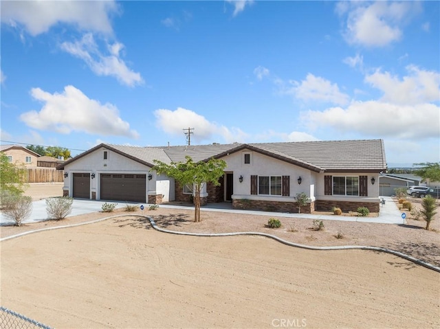 15679 Tuscola Rd, Apple Valley, CA 92307 - single story home with a garage, concrete driveway, stucco siding, a tile roof, and stone siding