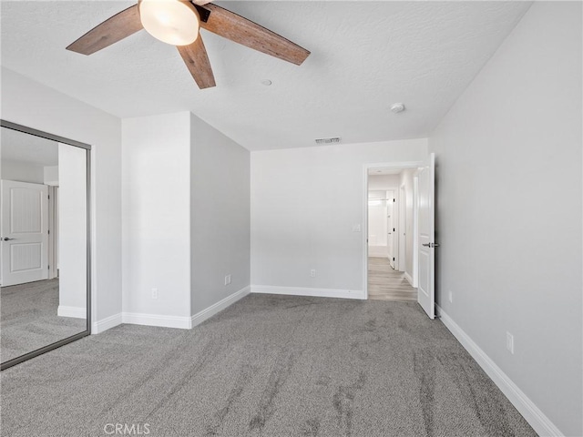 15679 Tuscola Rd, Apple Valley, CA 92307 - unfurnished bedroom with carpet floors, ceiling fan, and a textured ceiling