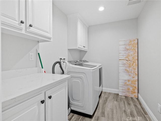 15679 Tuscola Rd, Apple Valley, CA 92307 - laundry area with cabinet space, washing machine and clothes dryer, light wood-style floors, and recessed lighting