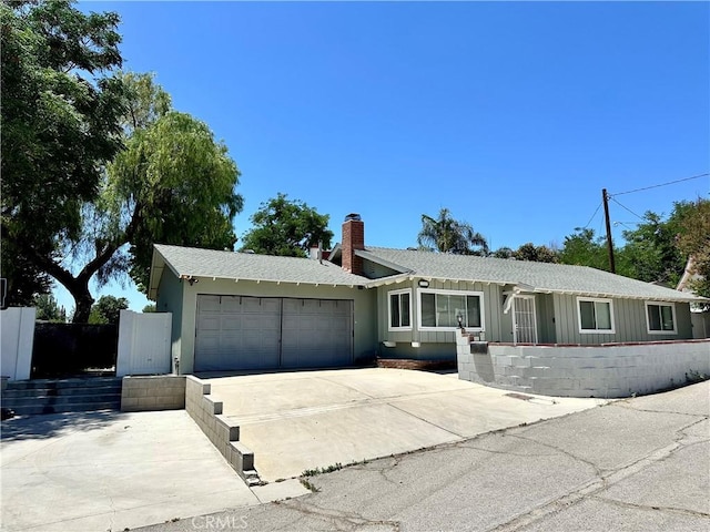 27820 Ferguson Dr, Castaic, CA 91384 - single story home featuring a garage, concrete driveway, and a chimney