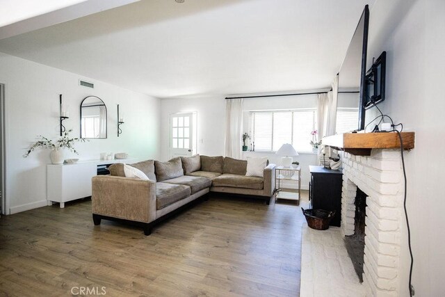 27820 Ferguson Dr, Castaic, CA 91384 - living room featuring wood finished floors and a fireplace