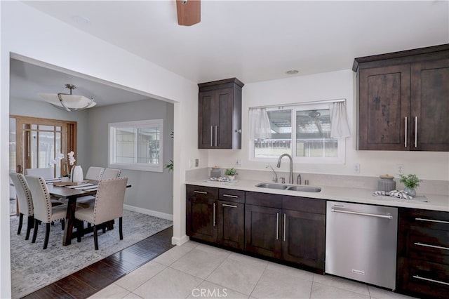 6804 Elm, Cypress, CA 90630 - kitchen with stainless steel dishwasher, light countertops, dark brown cabinetry, and light tile patterned floors