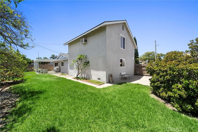 16660 Spruce Cir, Fountain Valley, CA 92708 - rear view of house with stucco siding, a patio area, a fenced backyard, and a wall mounted air conditioner