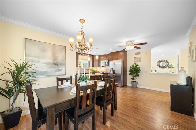 16660 Spruce Cir, Fountain Valley, CA 92708 - dining space featuring light wood-style floors, a ceiling fan, a chandelier, crown molding, and recessed lighting