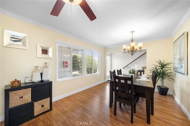 16660 Spruce Cir, Fountain Valley, CA 92708 - dining space with a chandelier, wood finished floors, crown molding, and a ceiling fan