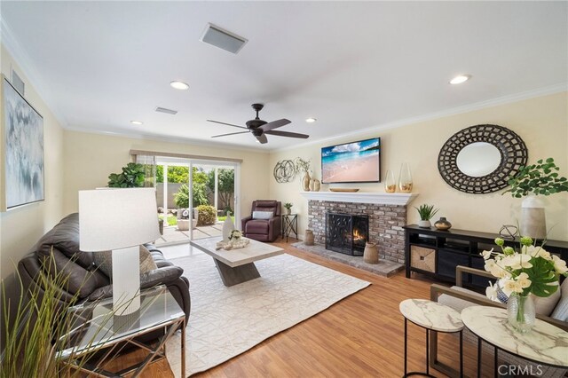 16660 Spruce Cir, Fountain Valley, CA 92708 - living room with ornamental molding, ceiling fan, wood finished floors, a brick fireplace, and recessed lighting