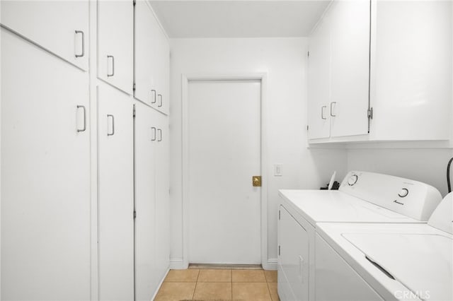 16660 Spruce Cir, Fountain Valley, CA 92708 - laundry room with cabinet space, washer and clothes dryer, and light tile patterned flooring