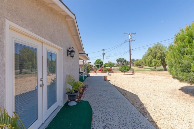 26866 Oakmont Dr, Menifee, CA 92586 - view of yard featuring french doors and a patio area