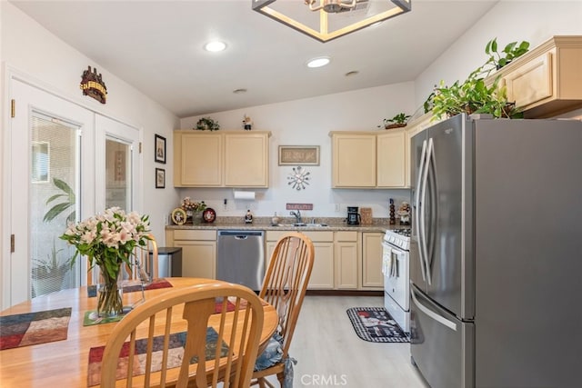 26866 Oakmont Dr, Menifee, CA 92586 - kitchen featuring stainless steel appliances, vaulted ceiling, light wood-type flooring, recessed lighting, and cream cabinetry