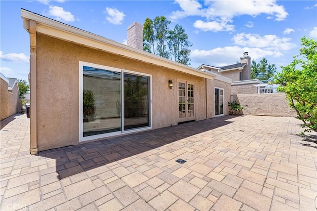 28082 Palmetto Ct, Laguna Niguel, CA 92677 - rear view of property with stucco siding, a patio, and a chimney