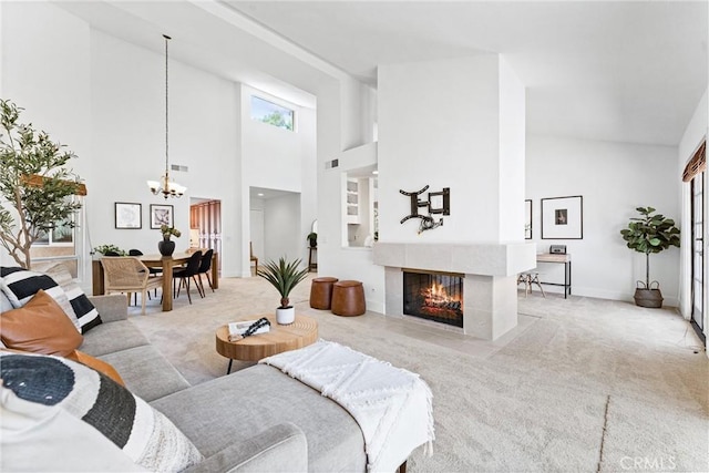 28082 Palmetto Ct, Laguna Niguel, CA 92677 - living room featuring high vaulted ceiling, a chandelier, light colored carpet, and a tiled fireplace