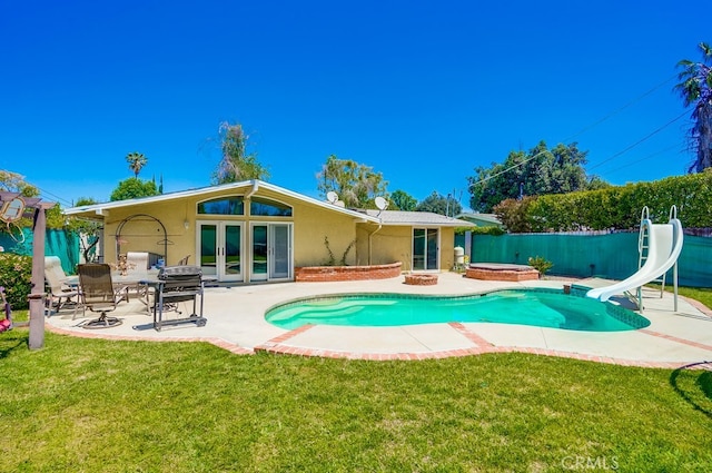 20606 Skouras Dr, Winnetka, CA 91306 - back of property featuring stucco siding, a jacuzzi, a fenced backyard, french doors, and a patio area