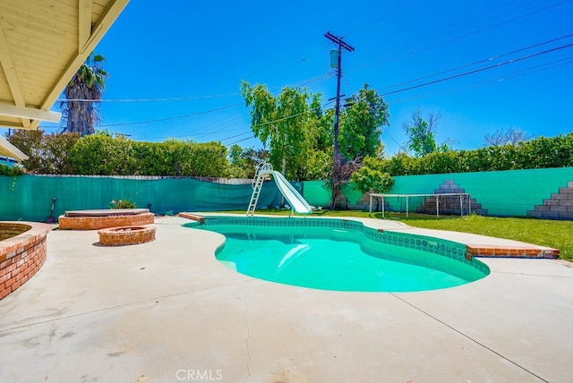 20606 Skouras Dr, Winnetka, CA 91306 - view of pool with a water slide, a patio area, and a fenced backyard