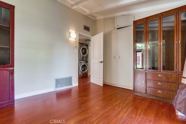 20606 Skouras Dr, Winnetka, CA 91306 - unfurnished bedroom with stacked washer / dryer, wood finished floors, and beam ceiling