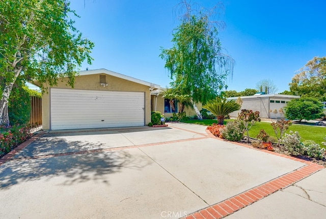 20606 Skouras Dr, Winnetka, CA 91306 - view of front of property with a garage, concrete driveway, and stucco siding