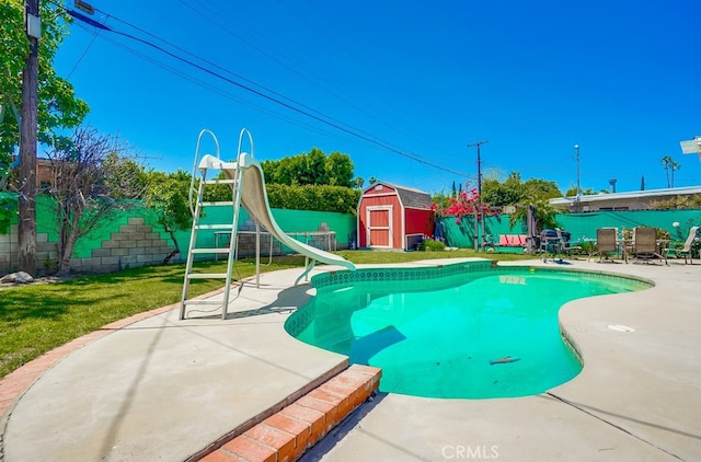 20606 Skouras Dr, Winnetka, CA 91306 - view of pool featuring a water slide, a fenced backyard, a patio, a storage unit, and a playground