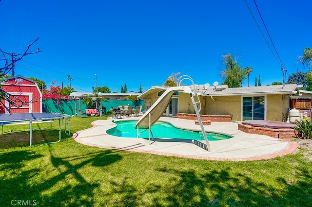 20606 Skouras Dr, Winnetka, CA 91306 - view of play area featuring a patio area, a trampoline, a fenced backyard, and a storage shed