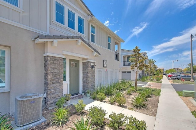 16502 Casa Grande Ave Unit 413, Fontana, CA 92336 - property entrance featuring board and batten siding, stone siding, stucco siding, and an attached garage