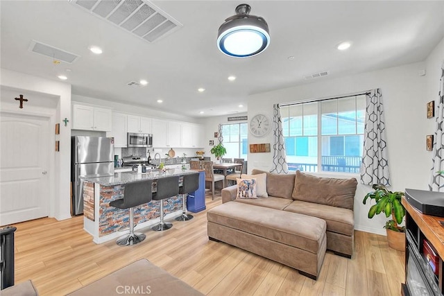 16502 Casa Grande Ave Unit 413, Fontana, CA 92336 - living room with light wood-style flooring and recessed lighting