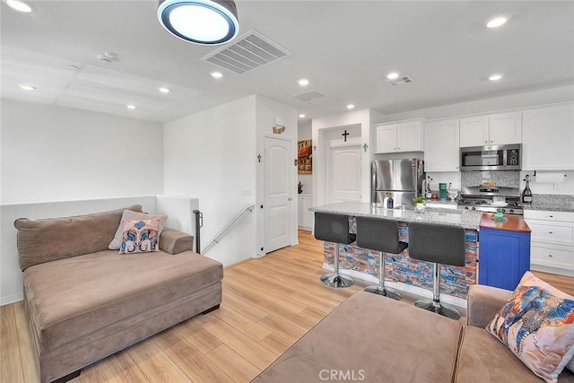 16502 Casa Grande Ave Unit 413, Fontana, CA 92336 - living room featuring light wood-style floors and recessed lighting