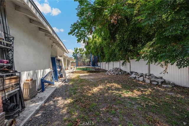 1411 Woodcrest Ave, La Habra, CA 90631 - fenced backyard featuring a trampoline