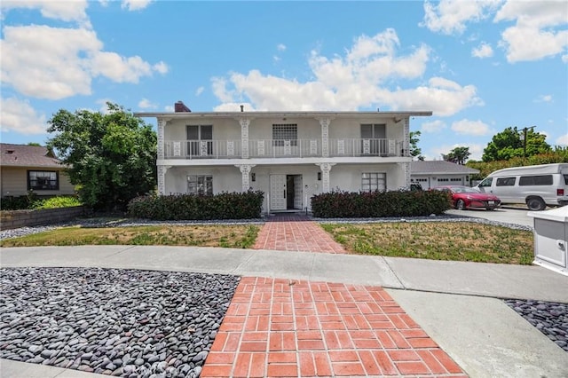 1411 Woodcrest Ave, La Habra, CA 90631 - view of front facade featuring a balcony and a garage